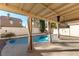 Inviting pool area with covered patio and privacy fence at 8217 Maplestar Rd, Las Vegas, NV 89128