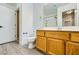 This is a full bathroom with a wood vanity, toilet, and a shower with glass doors at 8728 Honey Vine Ave, Las Vegas, NV 89143