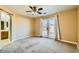 Large bedroom with carpet, ceiling fan, and backyard access at 8728 Honey Vine Ave, Las Vegas, NV 89143