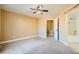 Bedroom featuring neutral carpet, ceiling fan, and en-suite bathroom at 8728 Honey Vine Ave, Las Vegas, NV 89143