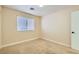 This bedroom features a window with blinds, carpet flooring, and neutral color walls at 8728 Honey Vine Ave, Las Vegas, NV 89143