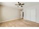 This comfortable bedroom features carpet floors, neutral walls, and a closet with sliding doors at 8728 Honey Vine Ave, Las Vegas, NV 89143