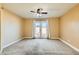 Spacious bedroom with neutral carpet and glass doors leading to the backyard at 8728 Honey Vine Ave, Las Vegas, NV 89143