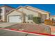 Single story home with neutral stucco, tile roof, rock landscaping, and a two car garage at 8728 Honey Vine Ave, Las Vegas, NV 89143