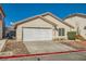 Single story home with neutral stucco, tile roof, rock landscaping, and a two car garage at 8728 Honey Vine Ave, Las Vegas, NV 89143