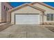 Close up of a two car garage door and driveway at 8728 Honey Vine Ave, Las Vegas, NV 89143