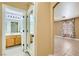 Hallway view featuring tile floors, bathroom entrance and views of the bedroom at 8728 Honey Vine Ave, Las Vegas, NV 89143