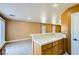 Open layout with kitchen bar connecting to a spacious living area with bright walls and tile floors at 8728 Honey Vine Ave, Las Vegas, NV 89143