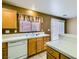 Kitchen featuring wood cabinets, white tile countertops, and a stainless steel faucet at 8728 Honey Vine Ave, Las Vegas, NV 89143