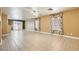 Spacious open floor plan with beige walls, tile flooring, and lots of natural light at 8728 Honey Vine Ave, Las Vegas, NV 89143