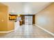 Open-concept living room featuring tile flooring and sliding glass doors to the backyard at 8728 Honey Vine Ave, Las Vegas, NV 89143