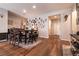 Dining area featuring wood-look tile flooring, gray wall color, and seating for six at 10417 Artful Stone Ave, Las Vegas, NV 89149