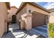 Exterior view of a home showcasing a secure wrought iron gate and a two-car garage at 10417 Artful Stone Ave, Las Vegas, NV 89149