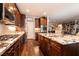 Gourmet kitchen featuring stainless steel appliances, granite countertops, and wood-look tile flooring at 10417 Artful Stone Ave, Las Vegas, NV 89149