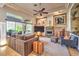 Bright living room featuring a fireplace, tray ceiling, comfortable seating, and views to the backyard at 10700 Back Plains Dr, Las Vegas, NV 89134