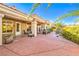 Covered outdoor patio with built in barbeque and seating area with manicured landscaping at 10700 Back Plains Dr, Las Vegas, NV 89134