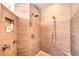 Modern walk-in shower with stone tile, multiple shower heads and built-in niche at 10700 Back Plains Dr, Las Vegas, NV 89134