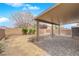 Backyard with stone-paved patio, partial cover, and block wall at 108 Fiery Hill Ave, Henderson, NV 89011