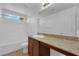 Bathroom featuring a shower-tub combo, wood cabinets, and granite countertops at 108 Fiery Hill Ave, Henderson, NV 89011