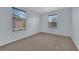 Bedroom with neutral walls and carpet and a view of the neighborhood through a window at 108 Fiery Hill Ave, Henderson, NV 89011