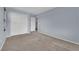 Bedroom with neutral walls, carpet, a closet, and a view into the laundry room at 108 Fiery Hill Ave, Henderson, NV 89011