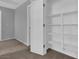 Open closet featuring built-in shelving and door to an adjacent bedroom at 108 Fiery Hill Ave, Henderson, NV 89011