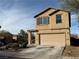 This two-story house boasts an attached garage and well-maintained landscaping at 108 Fiery Hill Ave, Henderson, NV 89011