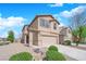 Inviting two-story home featuring a two-car garage and a well-maintained, xeriscaped front yard at 108 Fiery Hill Ave, Henderson, NV 89011