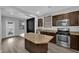 This kitchen includes wood cabinets, stainless steel appliances, and granite countertops at 108 Fiery Hill Ave, Henderson, NV 89011