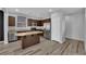 Well-lit kitchen features stainless steel appliances, granite countertops and stylish flooring at 108 Fiery Hill Ave, Henderson, NV 89011
