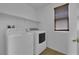 Laundry room featuring modern washer, dryer, and shelving at 108 Fiery Hill Ave, Henderson, NV 89011