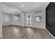 Open-concept living space featuring hardwood floors, access to the backyard and modern lighting fixtures at 108 Fiery Hill Ave, Henderson, NV 89011