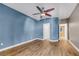 Large primary bedroom with hardwood floors, blue accent wall, and a ceiling fan at 108 Lemon Glaze St # 202, Las Vegas, NV 89145