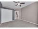 Neutral toned bedroom with a ceiling fan, a large closet with white doors and carpet floors at 108 Lemon Glaze St # 202, Las Vegas, NV 89145