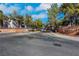 Gated community entrance featuring palm trees, well-maintained landscaping, and paved brick road at 108 Lemon Glaze St # 202, Las Vegas, NV 89145