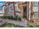 Inviting townhome entrance with a well-manicured lawn, mature trees, and a welcoming walkway at 108 Lemon Glaze St # 202, Las Vegas, NV 89145