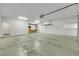 Clean garage space with overhead lighting, storage, and access door to the home at 108 Lemon Glaze St # 202, Las Vegas, NV 89145