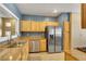 This kitchen features stainless steel appliances, wooden cabinetry, and granite countertops at 108 Lemon Glaze St # 202, Las Vegas, NV 89145