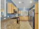 This kitchen features stainless steel appliances, wooden cabinetry, and granite countertops at 108 Lemon Glaze St # 202, Las Vegas, NV 89145