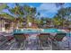 Community pool with lounge chairs surrounded by lush landscaping and palm trees on a sunny day at 108 Lemon Glaze St # 202, Las Vegas, NV 89145