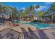 Community pool and lounge area featuring palm trees, lounge chairs, and resort style ammenities at 108 Lemon Glaze St # 202, Las Vegas, NV 89145