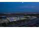 Night aerial view showcasing Downtown Summerlin shopping center lights and the city skyline at 11099 Moonlight Fire Ct, Las Vegas, NV 89135