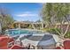 The perfect backyard has a sparkling pool, cozy firepit, and ample seating for entertaining at 11099 Moonlight Fire Ct, Las Vegas, NV 89135