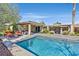 Gorgeous backyard featuring a refreshing swimming pool, outdoor kitchen, and covered patio area at 11099 Moonlight Fire Ct, Las Vegas, NV 89135
