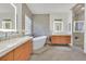 Luxurious bathroom with double vanities, a soaking tub, and a separate glass shower at 11099 Moonlight Fire Ct, Las Vegas, NV 89135