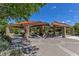 Spacious community pavilion with picnic tables and a grill, perfect for gatherings, surrounded by green space and landscaping at 11099 Moonlight Fire Ct, Las Vegas, NV 89135