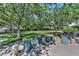 Inviting community space featuring comfortable seating among mature trees and a verdant green, providing a natural gathering space at 11099 Moonlight Fire Ct, Las Vegas, NV 89135
