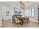 Stylish dining area with bench seating, modern lighting, and elegant window shutters at 11099 Moonlight Fire Ct, Las Vegas, NV 89135