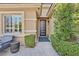Stylish front entry featuring a modern door, lush greenery, and elegant exterior details at 11099 Moonlight Fire Ct, Las Vegas, NV 89135