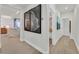 Bright hallway with hardwood floors leading to the kitchen and bathroom at 11099 Moonlight Fire Ct, Las Vegas, NV 89135